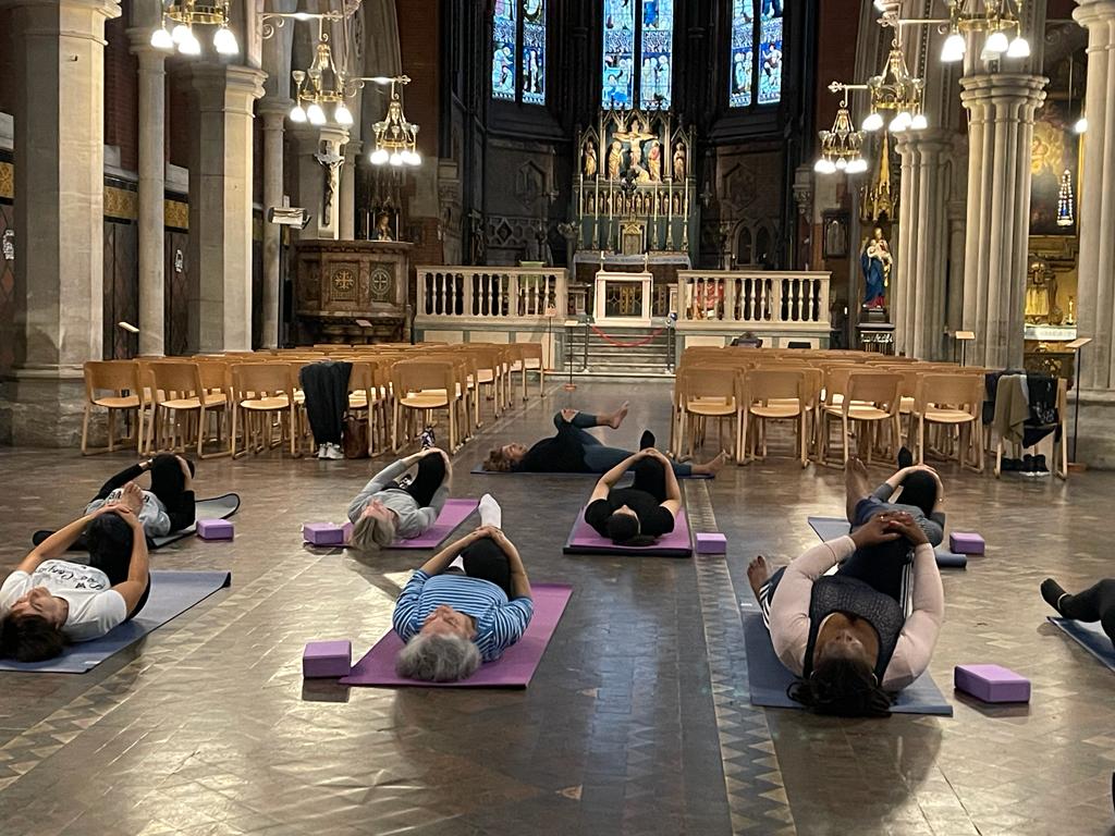 A group of people doing yoga in the church